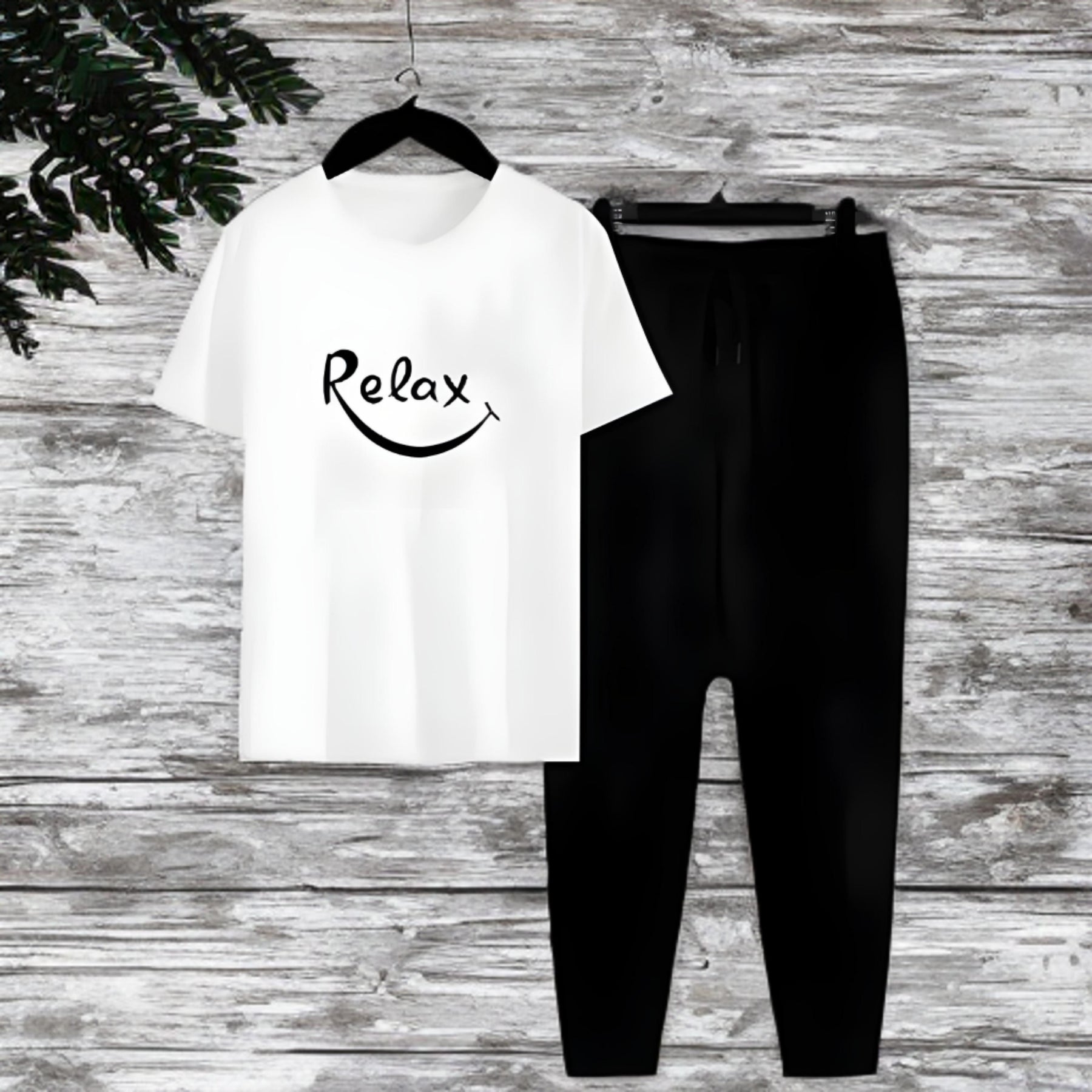 White t-shirt with 'Relax' text and black pants on a wooden surface