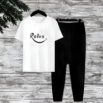 White t-shirt with 'Relax' text and black pants on a wooden surface
